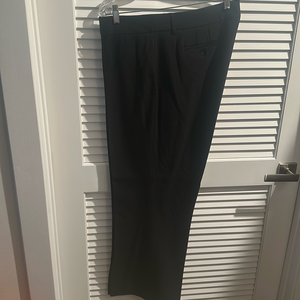 Apostrophe  women’s dress pants with back pocket and button closure.